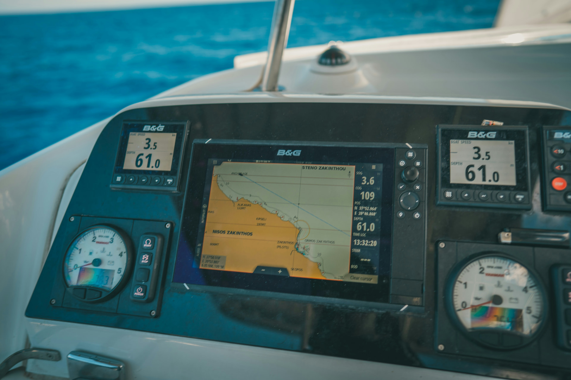 Marine engine instruments and chartplotter for boat log records Boat helm console with B and G chartplotter, tachometers and depth gauges at sea